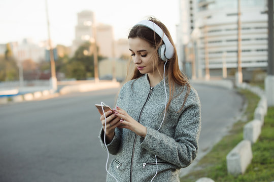 Woman listening to music with headphones in city