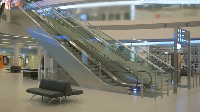 Empty airport terminal at night, empty escalator in the mall