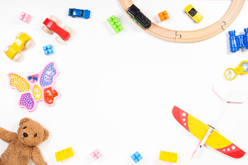 Colorful kids toys frame on white background. Top view. Flat lay.