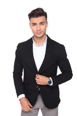 portrait of handsome businessman buttoning his black suit