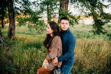 photo shoot of a beautiful brunette and her boyfriend in nature
