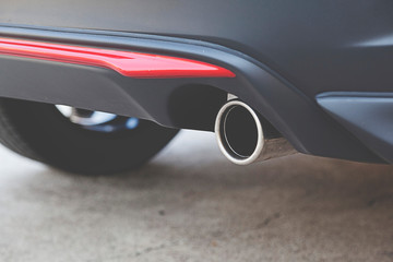 Close up detail exhaust pipe of a car.