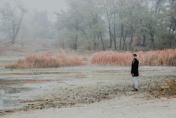 The lonely man walking outsides, where full of mist in morning