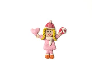 Pretty girl holding the pink heart and red gift box made from plasticine clay placed on white background, cute child dough wearing a coat in winter festival