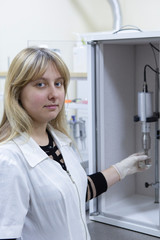 Female Laboratory Scientist Examining Sample In Test Tube