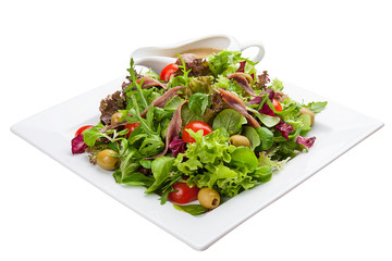 Salad with anchovies and vegetables on a white plate