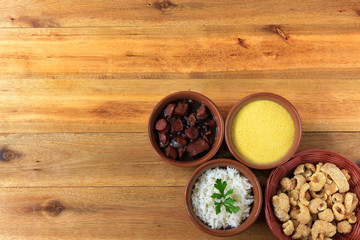 Obraz na płótnie Canvas Brazilian feijoada, traditional dish of the Brazilian cuisine, on wooden table