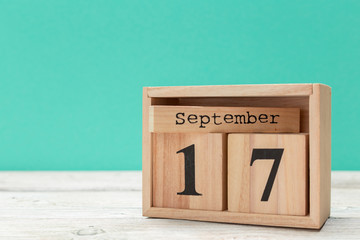 wooden cube shape calendar for september 17 on wooden tabletop