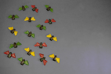 multicolored gummy jelly bat candies over dark background