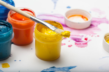 splashes of watercolor paint and painting supplies  close up
