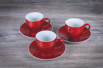 three red christmas mug on gray wooden background