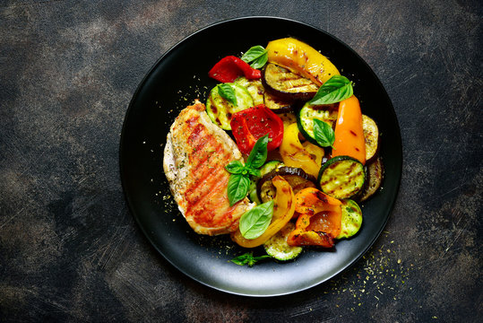 Grilled chiken fillet with vegetables.Top view.