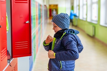 Child boy dressing his autumn jacket in school © Daniel Jędzura