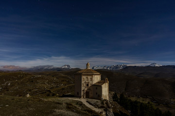 Rocca Calascio Fortress with moon Light Time, with Shadow - A Medieval Castle Built over the Peak of Mountain in Abruzzo - Italy, Corno Grande background
