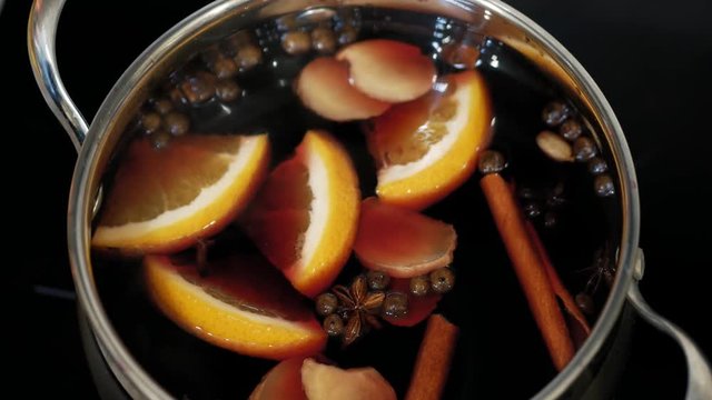 Cooking traditional drink for Christmas. Mulled wine preparations. High angle shot