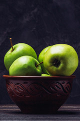Beautiful green apples in a clay bowl