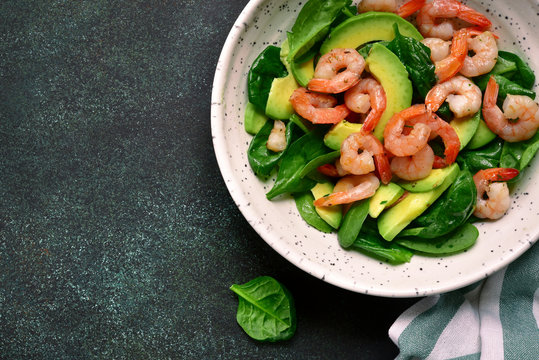 Avocado salad with baby spinach and shrimps.Top view.