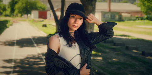 Beautiful girl in a black cap and jacket. Portrait of a girl.