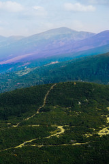 Alpine mountain landscape, summertime, green meadows, hiking trail.