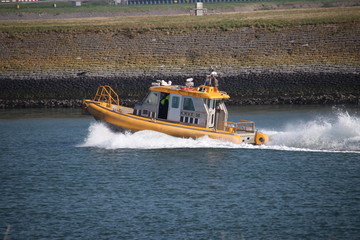 Fototapeta premium Pilot ship KRVE with high speed on the nieuwe waterweg in the port of Rotterdam.