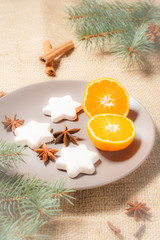 Gingerbread cookies in star shape and orange on plate