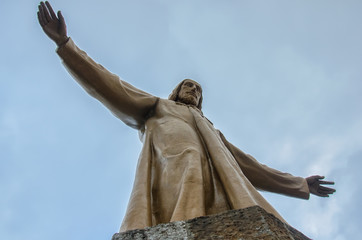 Statue of Christ on the top of temple of the Blazing Heart on the hill of Tibidabo in Barcelona, Spain.