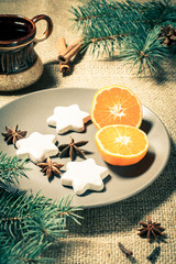 Gingerbread cookies in star shape and orange on plate