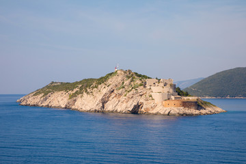 Fototapeta na wymiar Rt Ostra Light is point extremity of a narrow and rocky peninsula Prevlaka, entrance point of Boka Kotorska in Croatia
