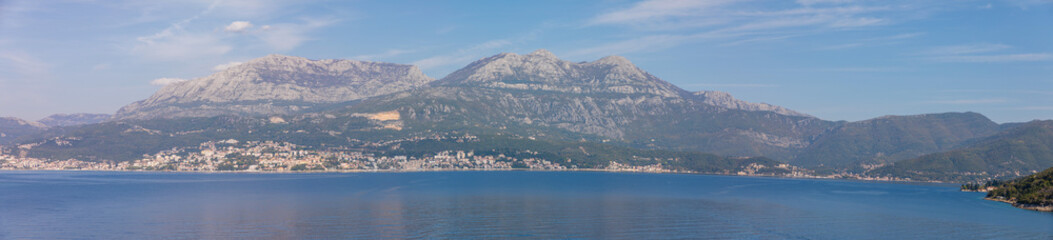 Fototapeta na wymiar Scenic view of old town, mountains and the coast from water of Kotor bay in Montenegro