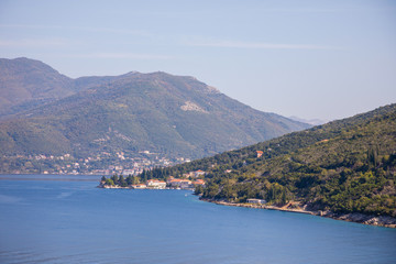 Fototapeta na wymiar Scenic view of old town, mountains and the coast from water of Kotor bay in Montenegro