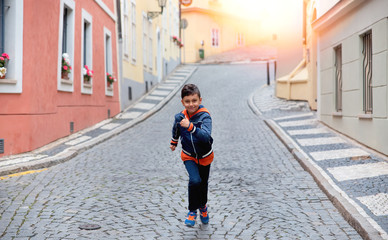  Portrait of a boy running up the street
