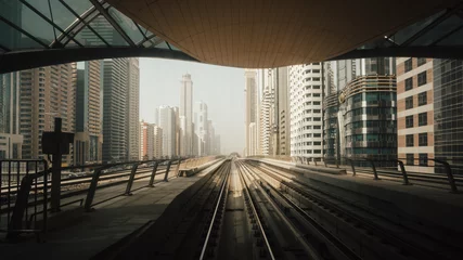 Tuinposter View from first railway carriage. Dubai city metro in the downtown © Ivan Kurmyshov