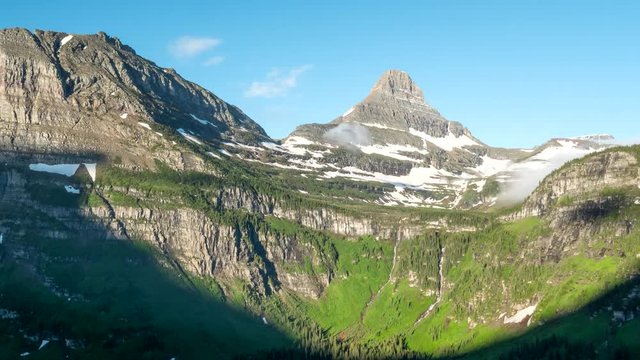 a morning time lapse of mist clearing from mt oberlin and logan pass at glacier national park in montana, usa