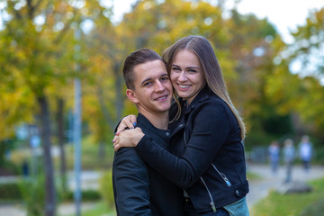 Fototapeta premium Young couple in love walking in the autumn park
