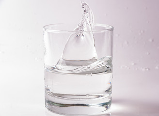 Glasses of water falling and jumping with splashes and drops	