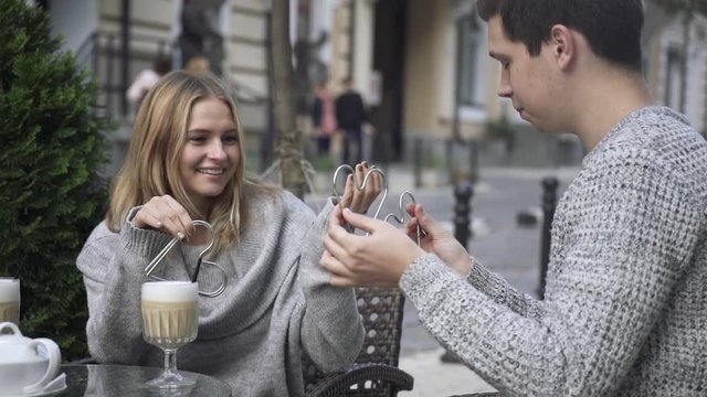 Illusionist shows trick with hearts.
