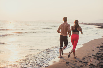 Man and Woman Running on Sandy beach