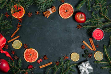 Fototapeta na wymiar Christmas food. Ingredients for Christmas baking: Christmas tree, kitchen utensils on a dark table, top view
