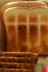 different types of bread in a bread basket for breakfast or tea time, slightly brown toasted bread...