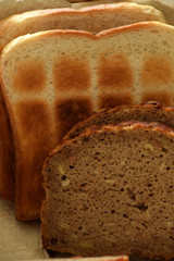 bread slices of grain bread and toast bread, different types of bread in a bread basket for...