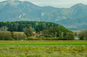 Ladnscape from Slovakia - green meadows and fields in the background the mountains