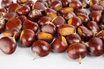 Fresh chestnuts with peeled roasted chestnut isolated on white background. Hippocastanum isolated.