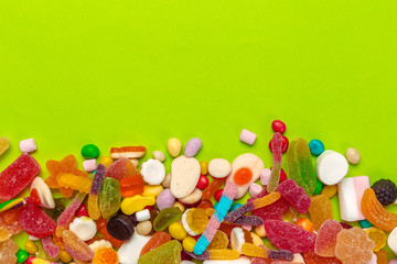 Fototapeta na wymiar Colorful candies on green background