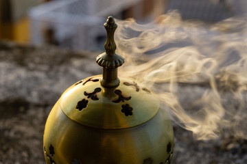 incense burner censer with smoke and blurred background. - obrazy, fototapety, plakaty