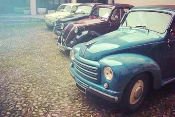 Fototapeten Vintage cars in a row. Copy space available on the left © missizio01