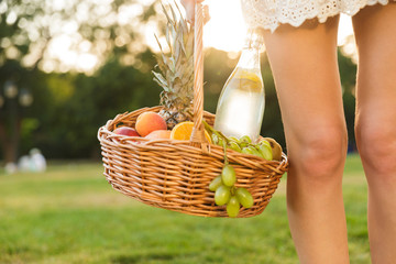 Close up of a woman holding picnic basket