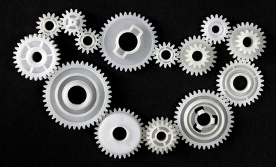 Several gears that are in connection with each other on black background