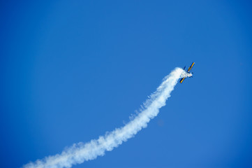 Airplanes on aerobatic performs flight and beautiful smoke trail..