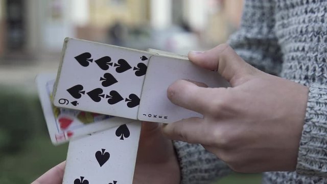 The illusionist shows trick with a deck of cards