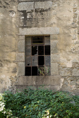 Old broken window of an abandoned factory